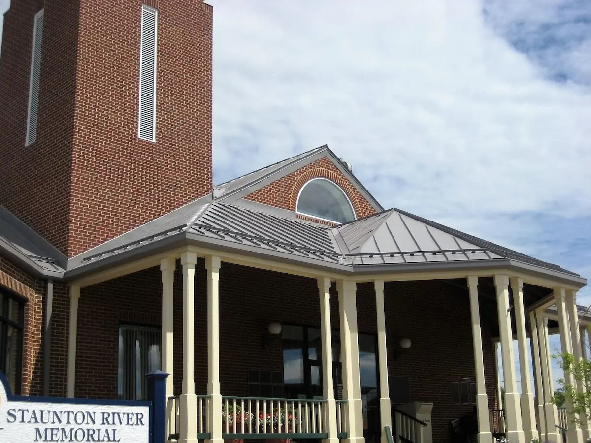 Skilled roofing craftsmen working on a residential roof in Greenfield